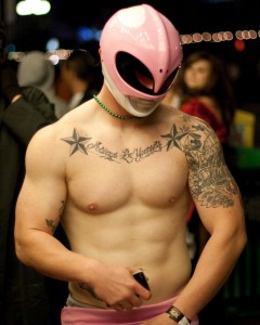 Muscular young man dressed as the pink Power Ranger