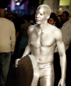 Young man in silver body paint.